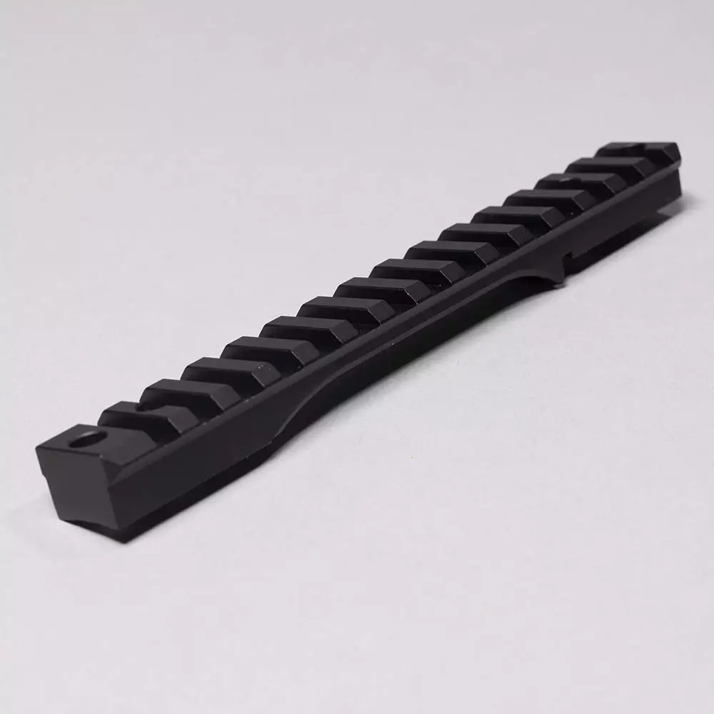 Black tactical Picatinny rail on gray background