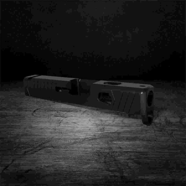 Black firearm slide on dark surface