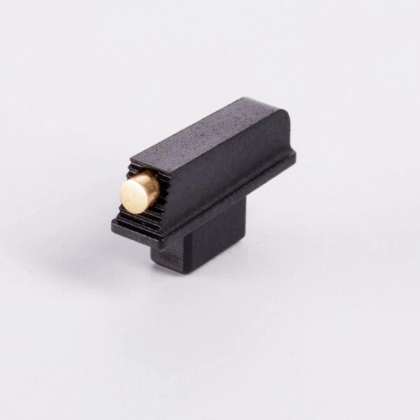 Black metal component with a brass pin