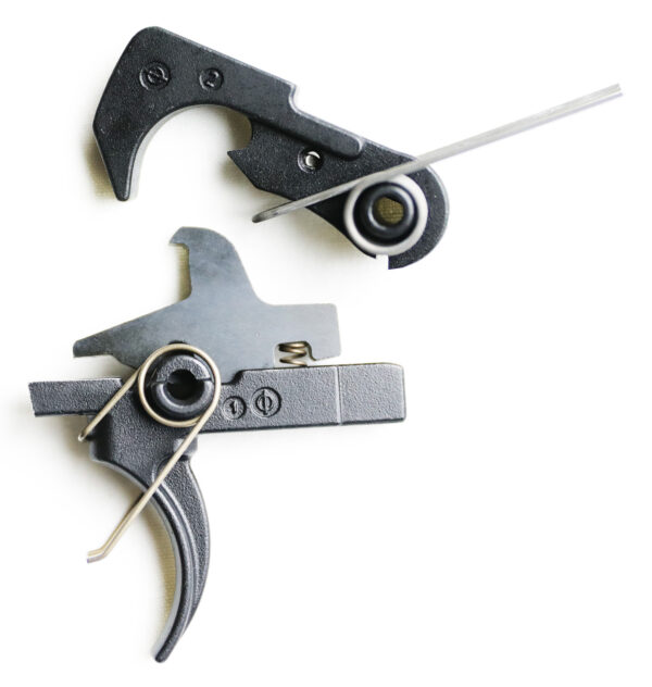 Close-up of firearm trigger components on white background.