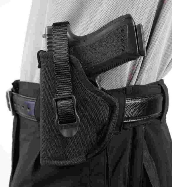 Handgun in a black tactical holster on a belt.
