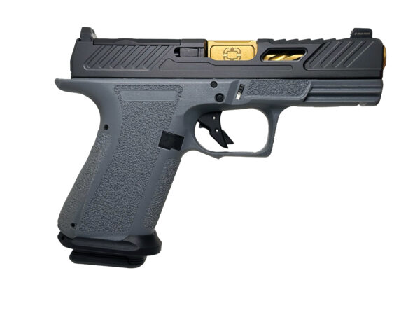 Gray handgun with gold accents side view