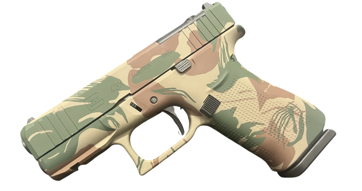 Camouflaged Glock 43X handgun on a white background.