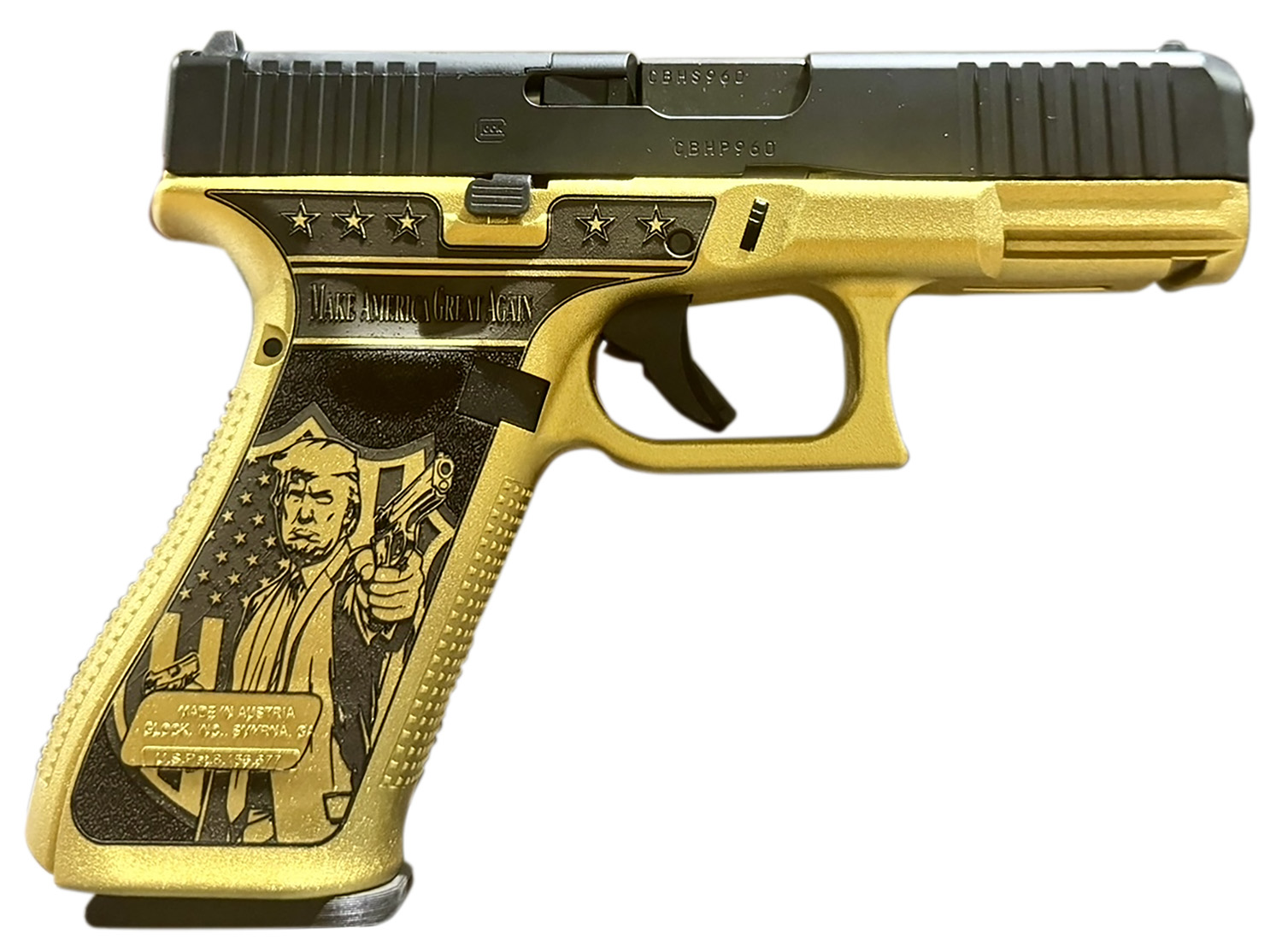 Custom gold pistol with engraved design.