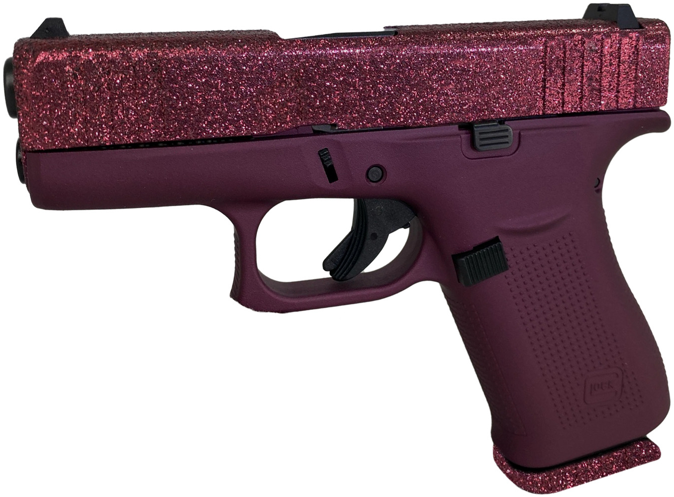 Pink glittery handgun on a white background.