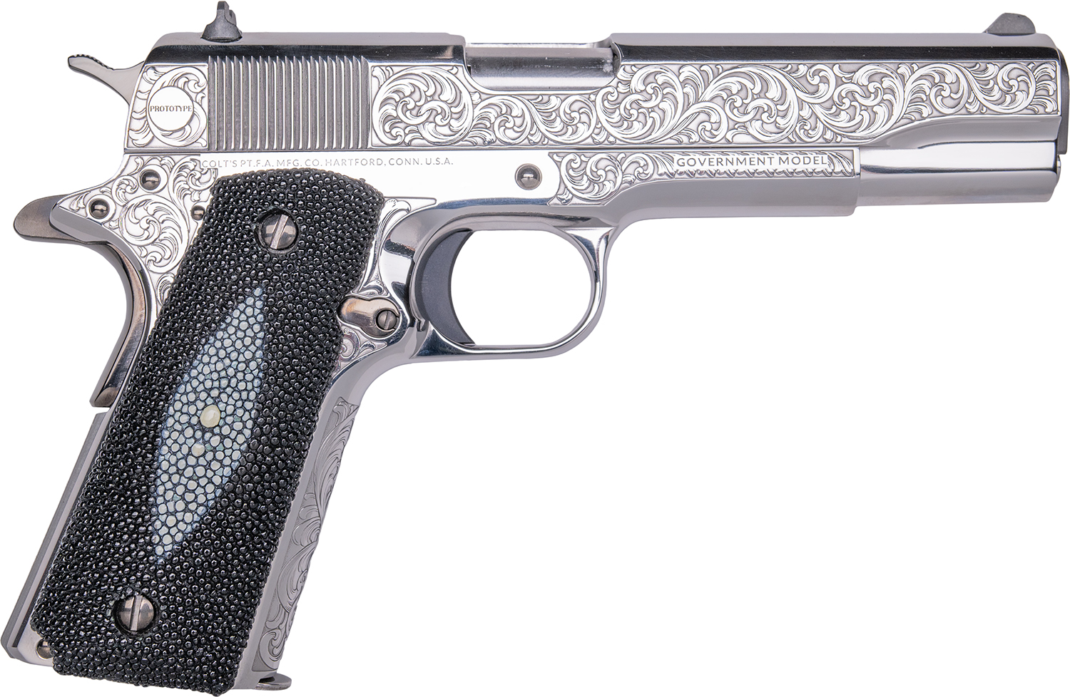 Engraved silver handgun with textured grip.