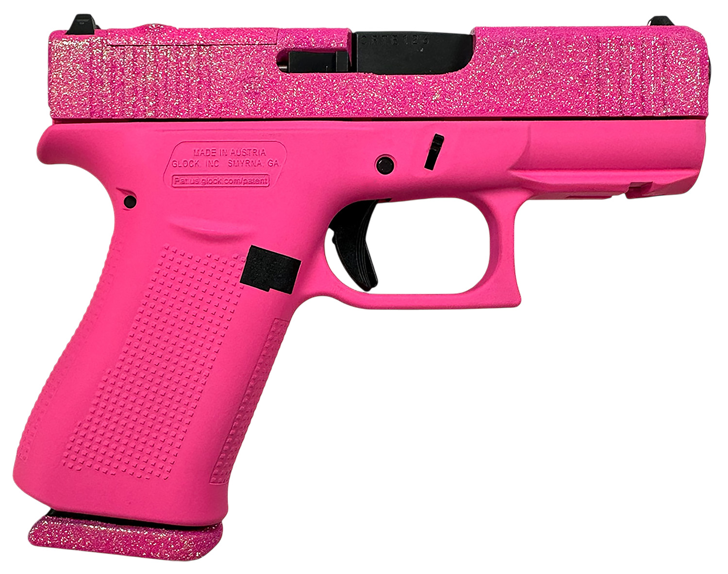 Pink glitter handgun on a white background