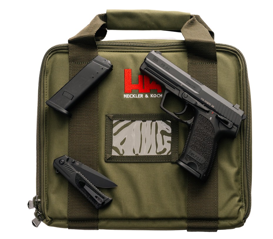 Heckler & Koch pistol with accessories on green bag.