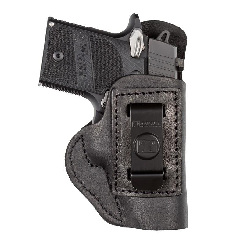 Handgun in leather holster, securely positioned.