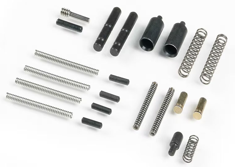 Assorted springs and metal components on white background