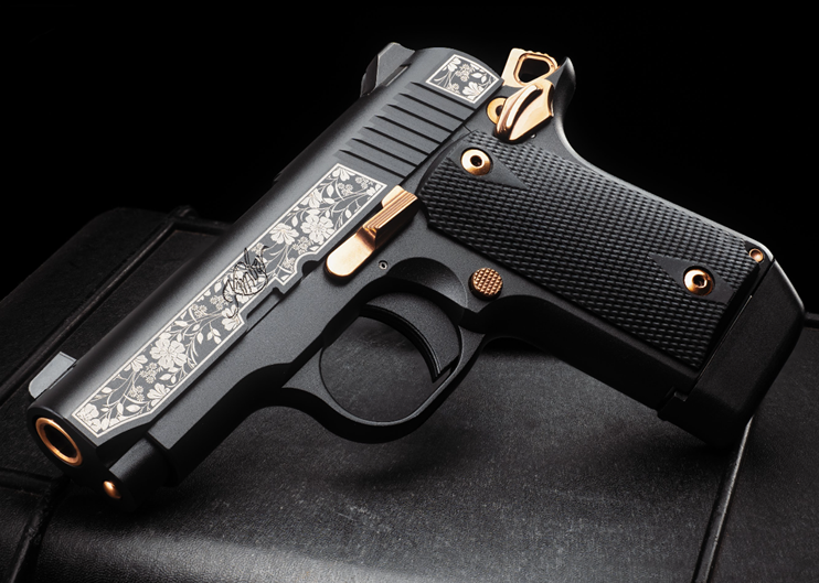 Stylish black and gold decorative handgun.