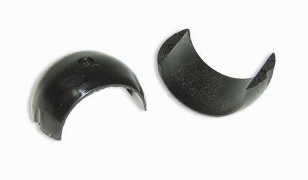 Two black plastic dome caps separated