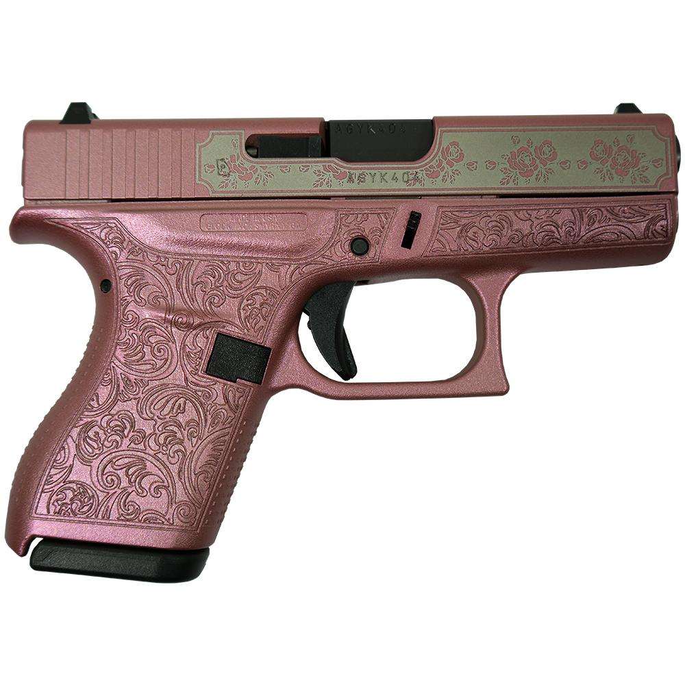 Pink decorative handgun with floral patterns.