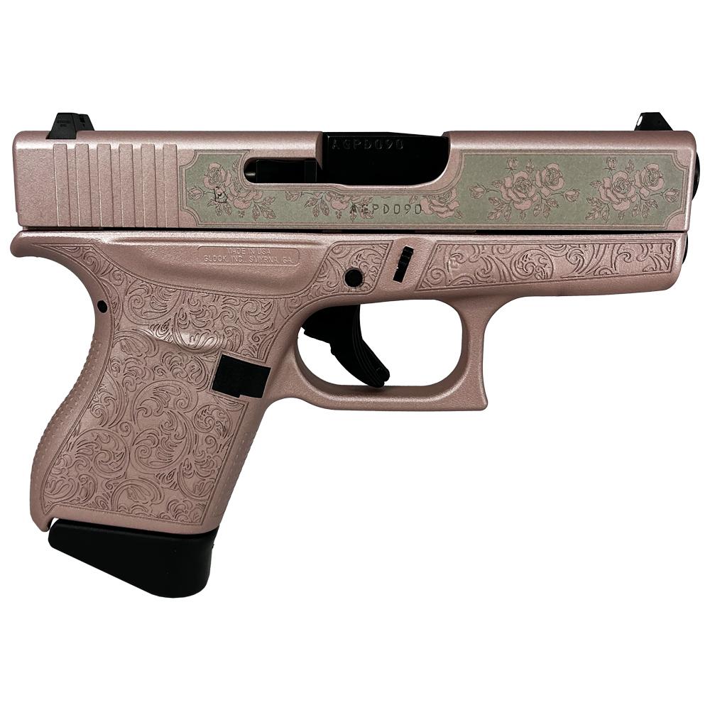 Decorative pink handgun with floral patterns.