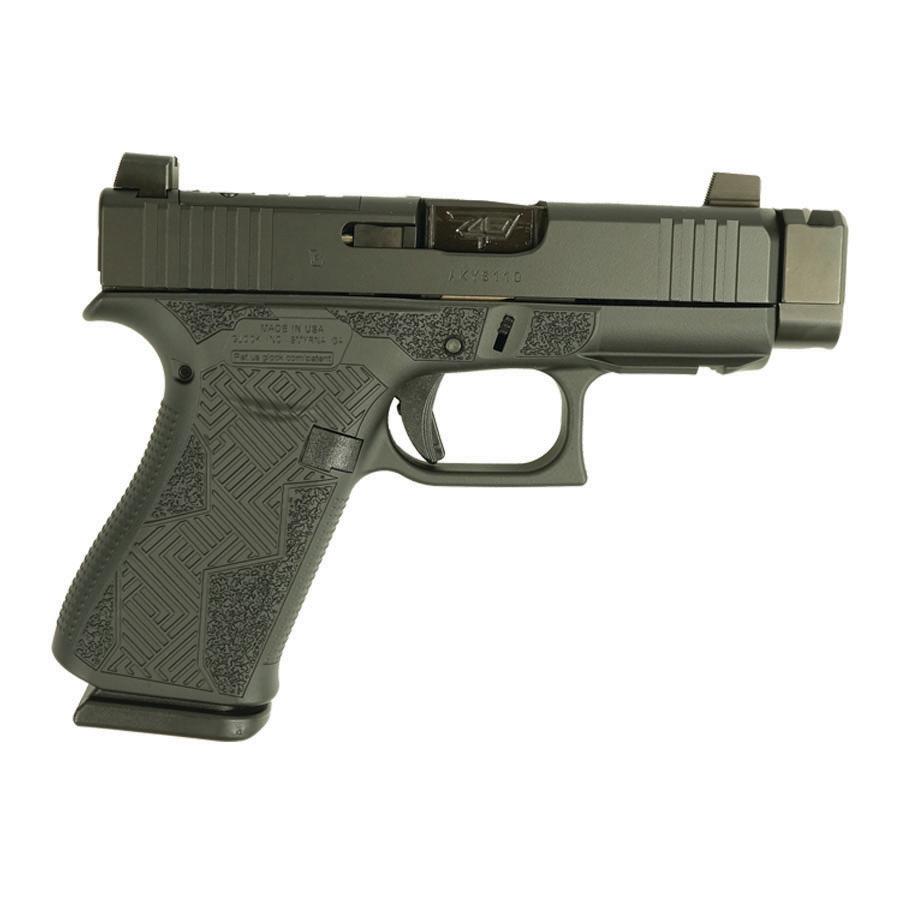 Green handgun with textured grip and safety features