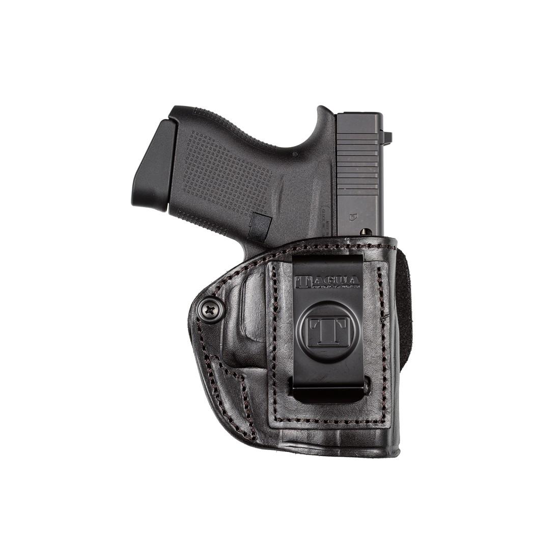 Black handgun in a leather holster.