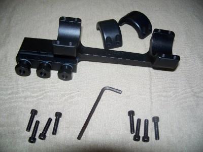 Black mounting hardware and screws on a surface.