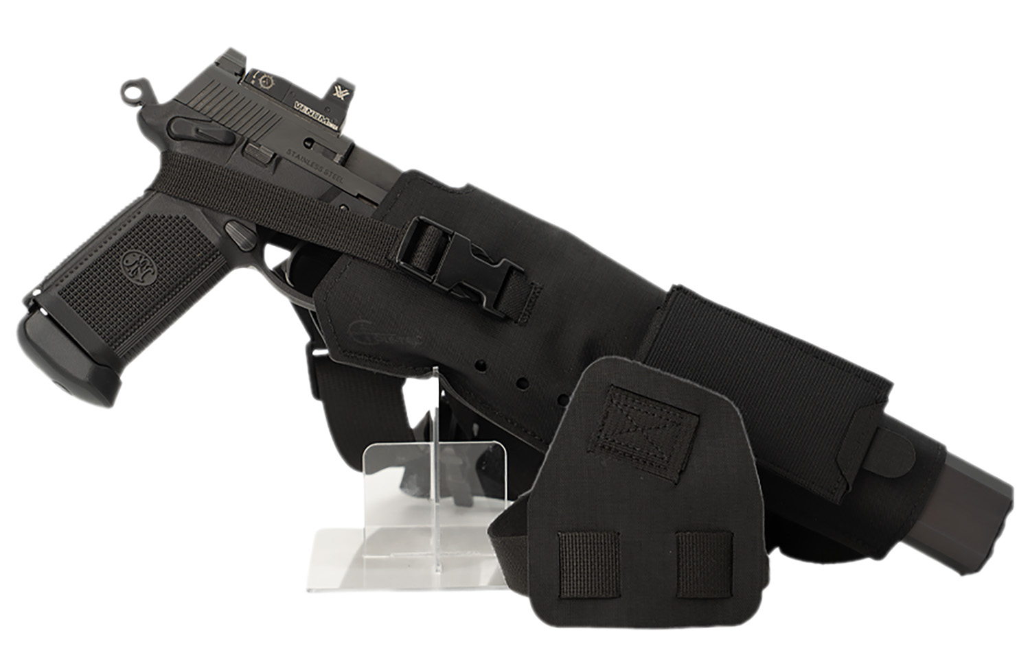 Black handgun in tactical holster on stand