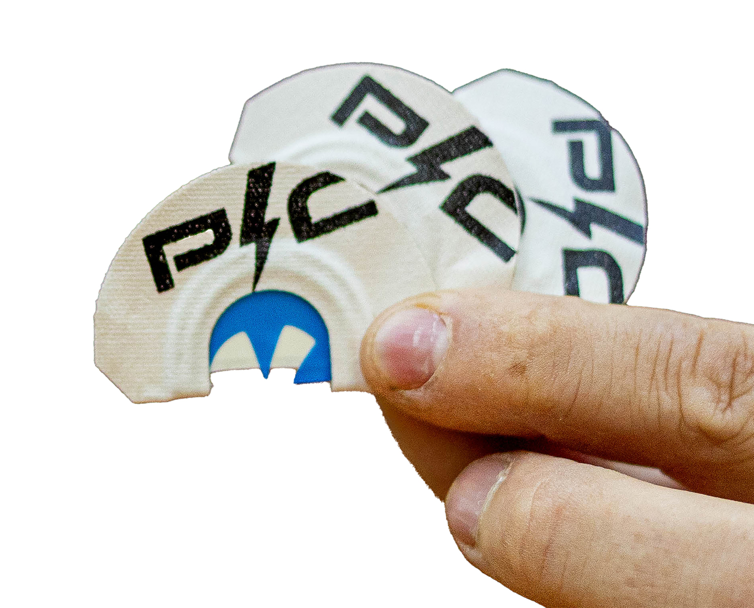 Hand holding branded guitar picks with logos
