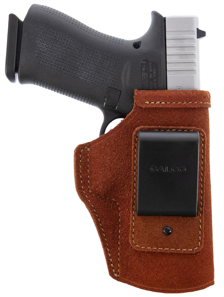 Handgun in brown leather holster with belt clip