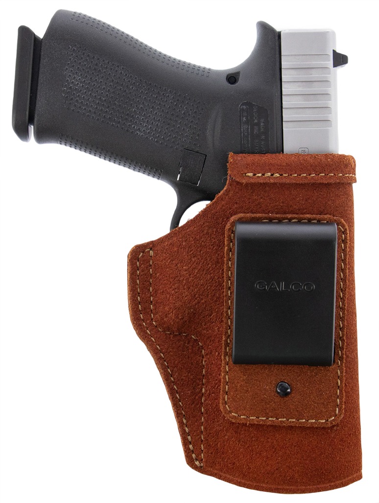 Handgun in brown leather holster with belt clip