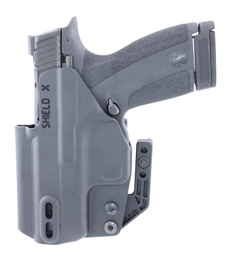 Gray handgun in molded holster with belt clip