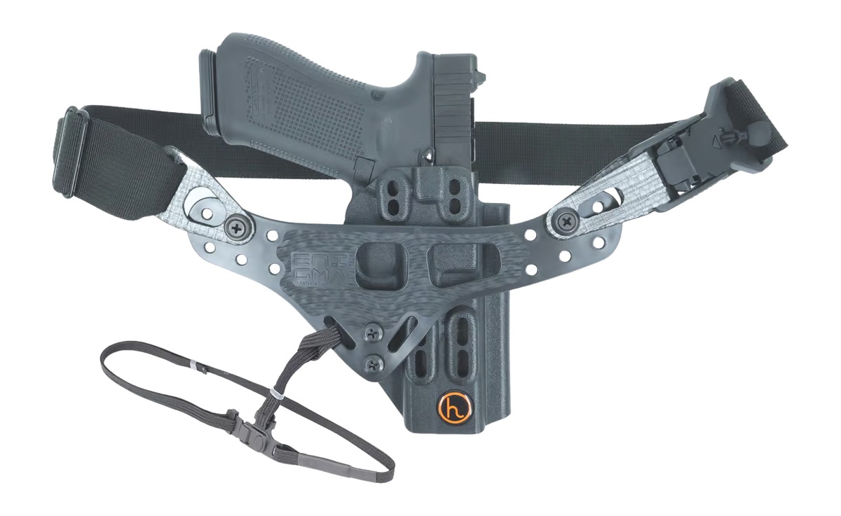 Handgun in tactical belt holster with attachments