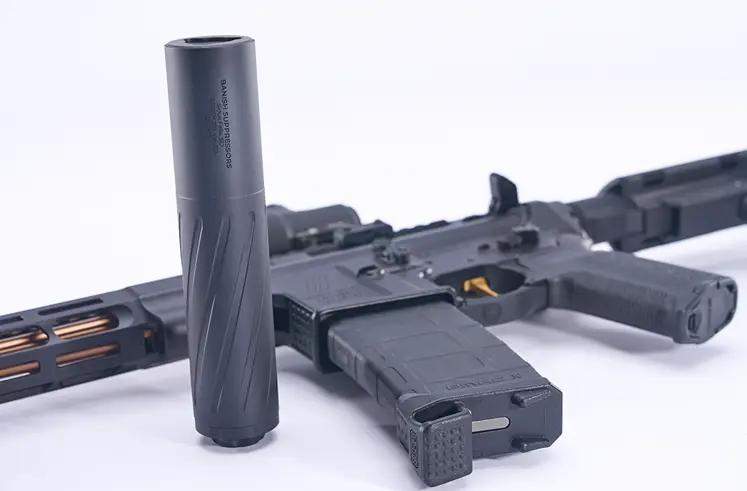 Rifle with detachable suppressor on white background