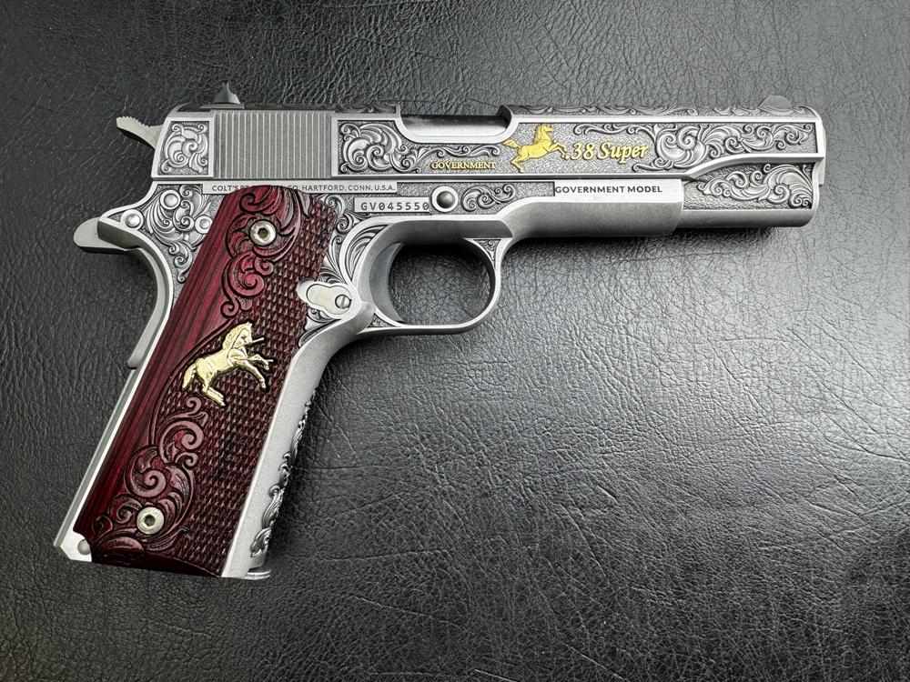 Detailed silver and wood engraved handgun