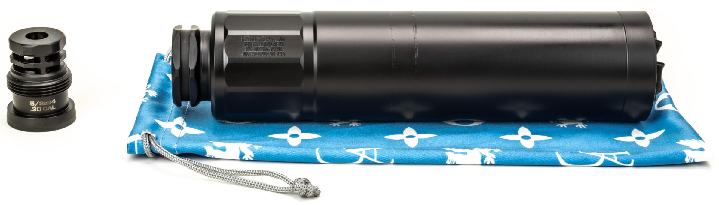 Black firearm suppressor with threaded adapter on cloth
