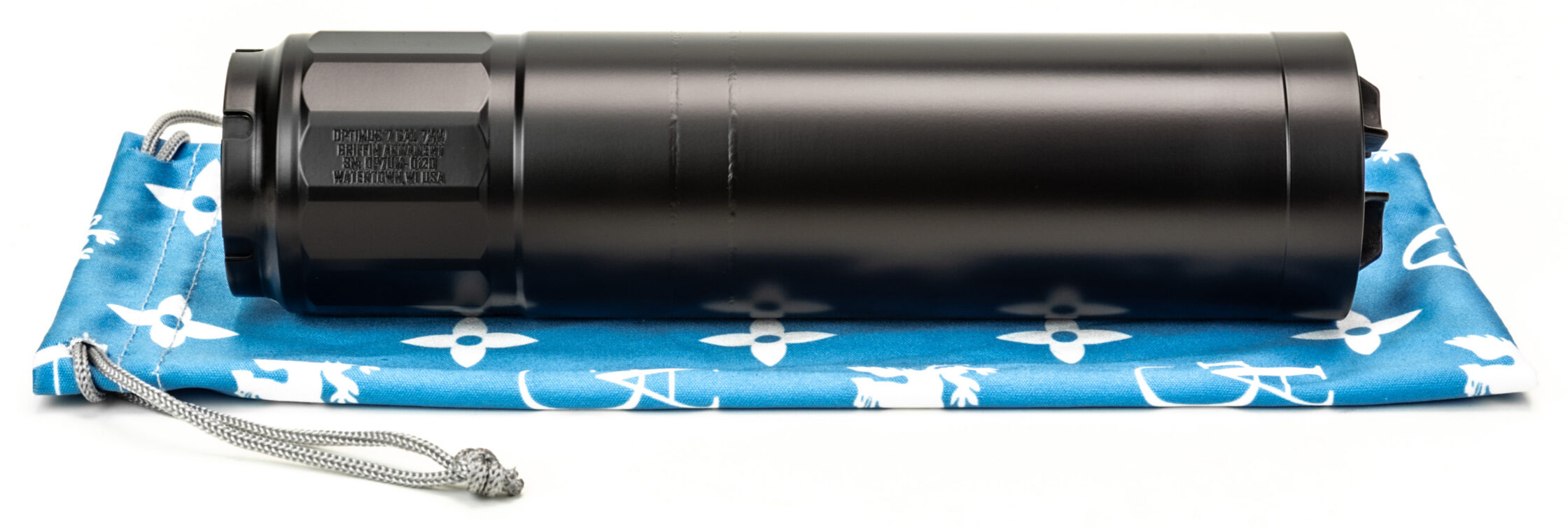 Black firearm suppressor on blue patterned pouch
