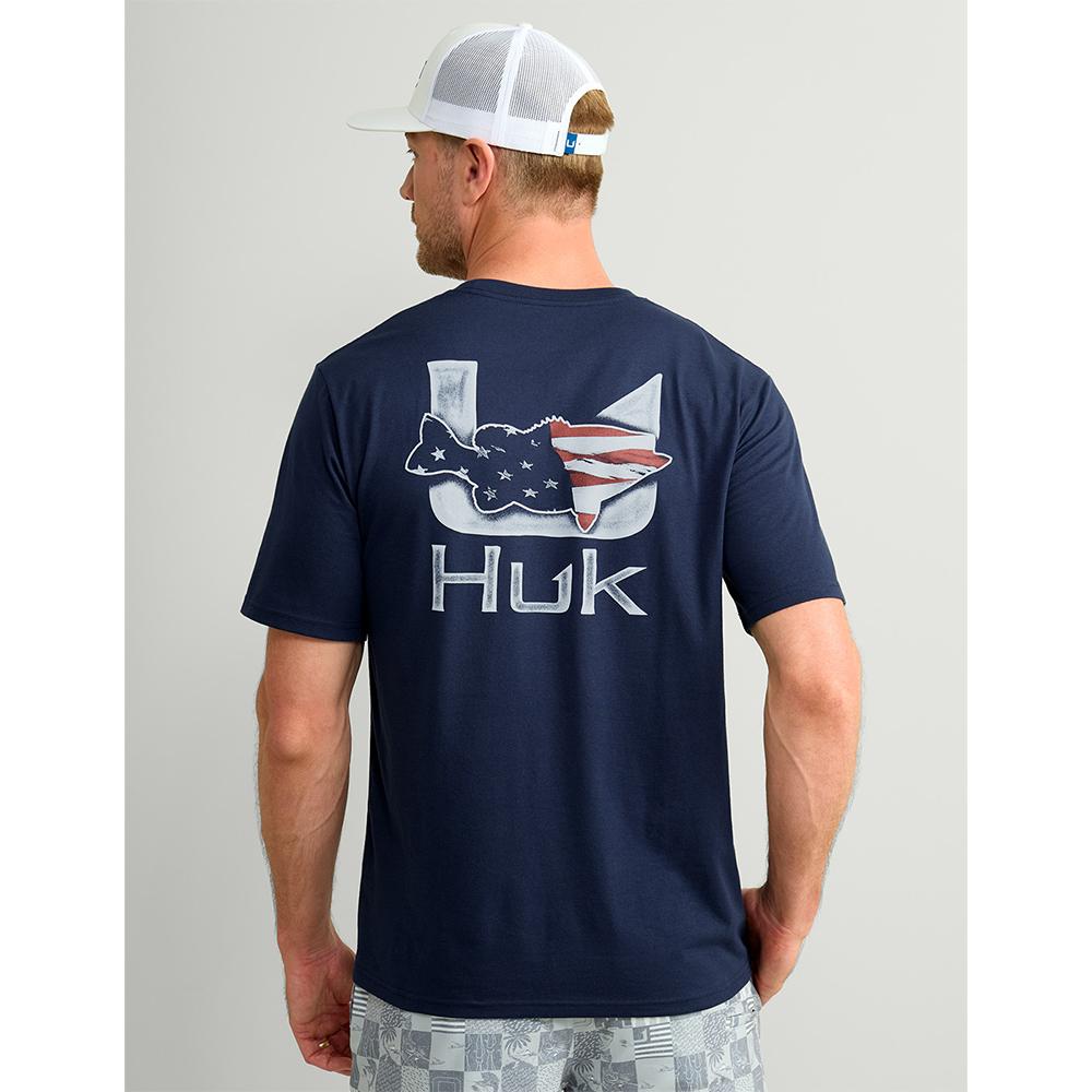 Man wearing navy Huk graphic T-shirt