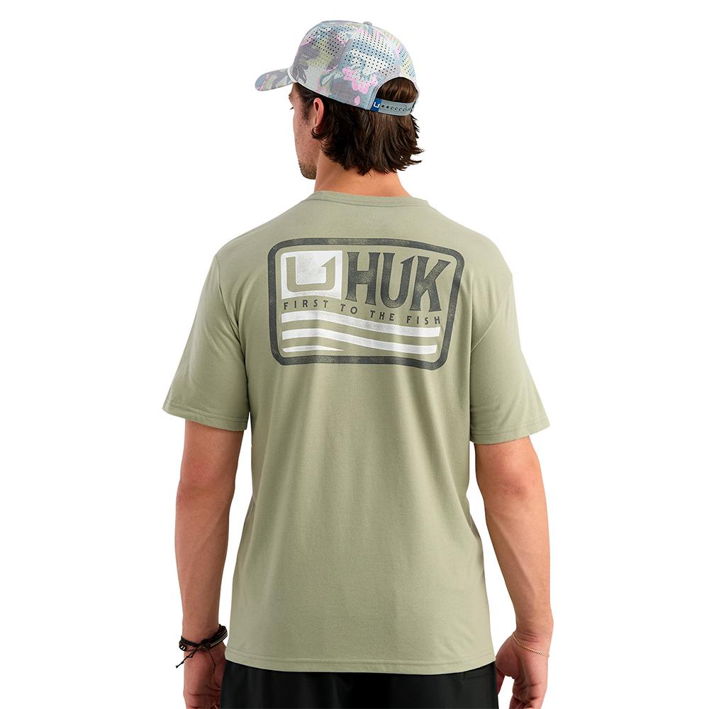 Back view of man wearing HUK graphic T-shirt
