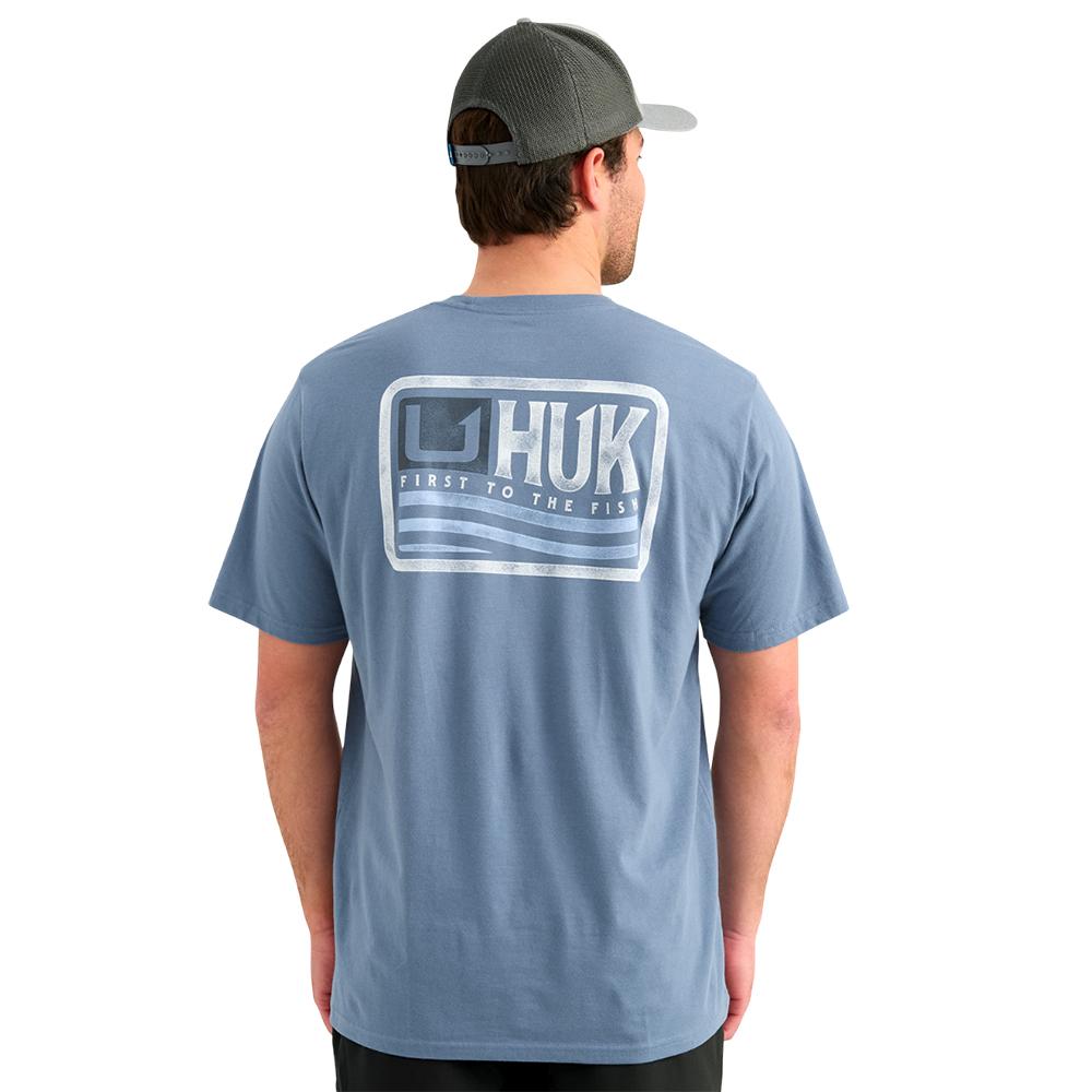 Man wearing blue Huk logo t-shirt