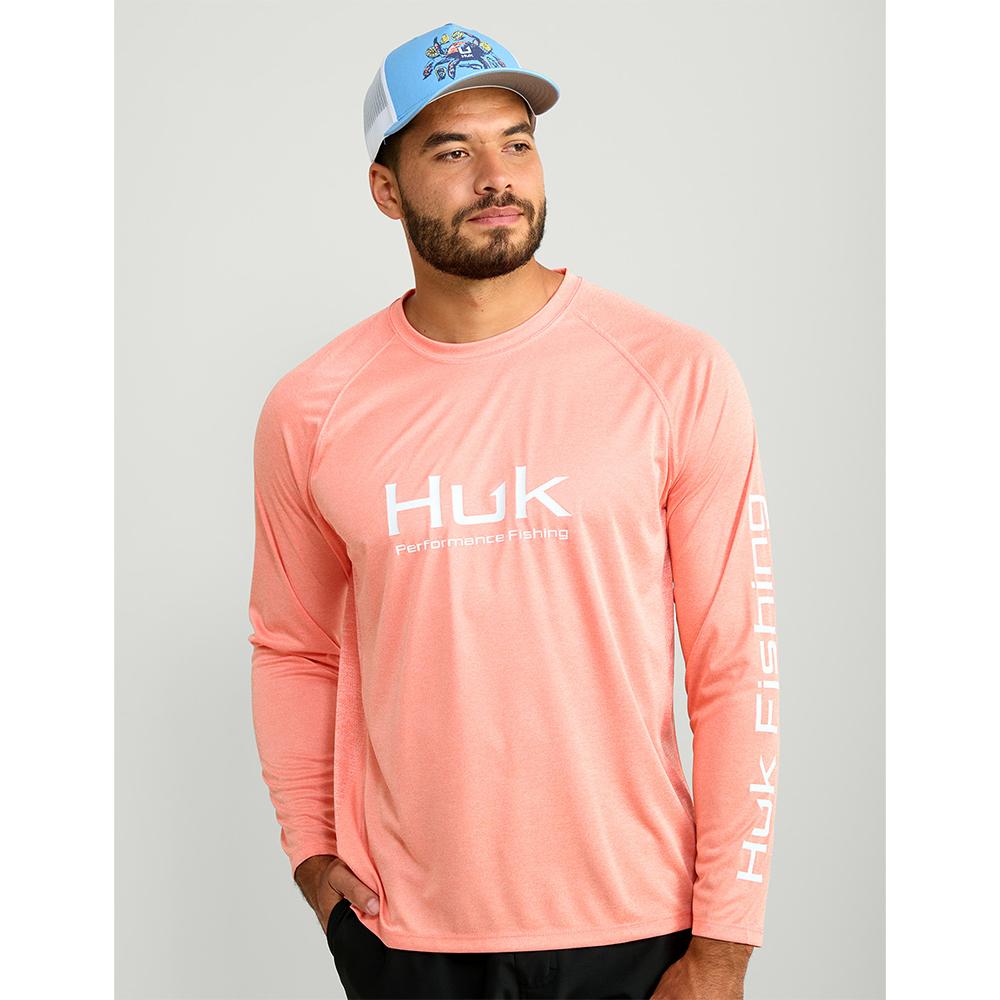 Man wearing coral Huk fishing shirt and cap