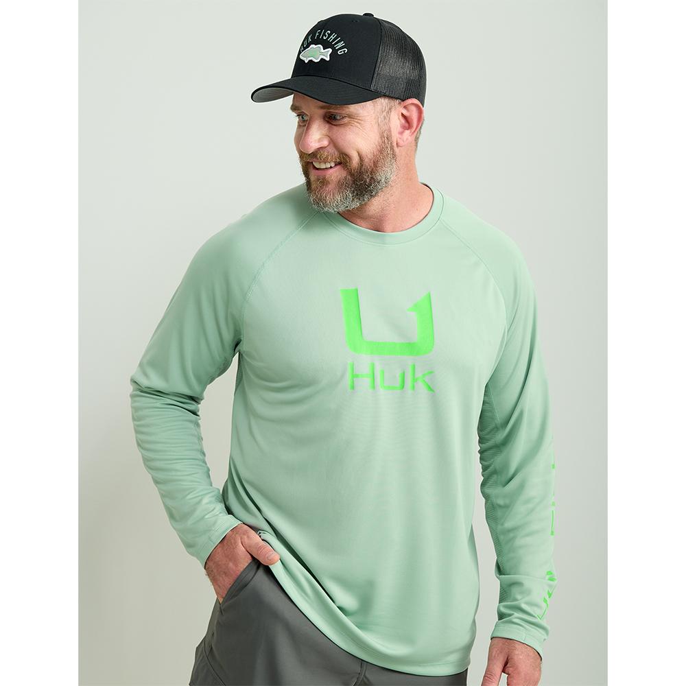 Man wearing mint green Huk fishing shirt