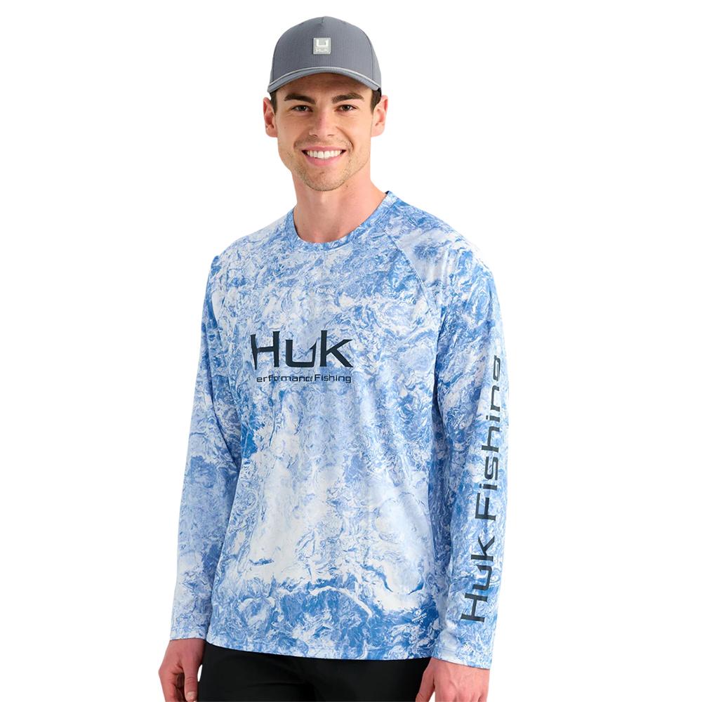 Man wearing blue Huk fishing shirt and cap