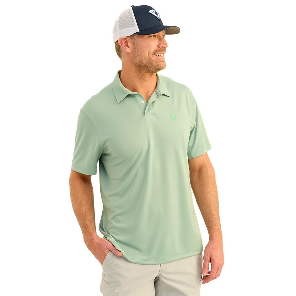 Man wearing green polo and baseball cap