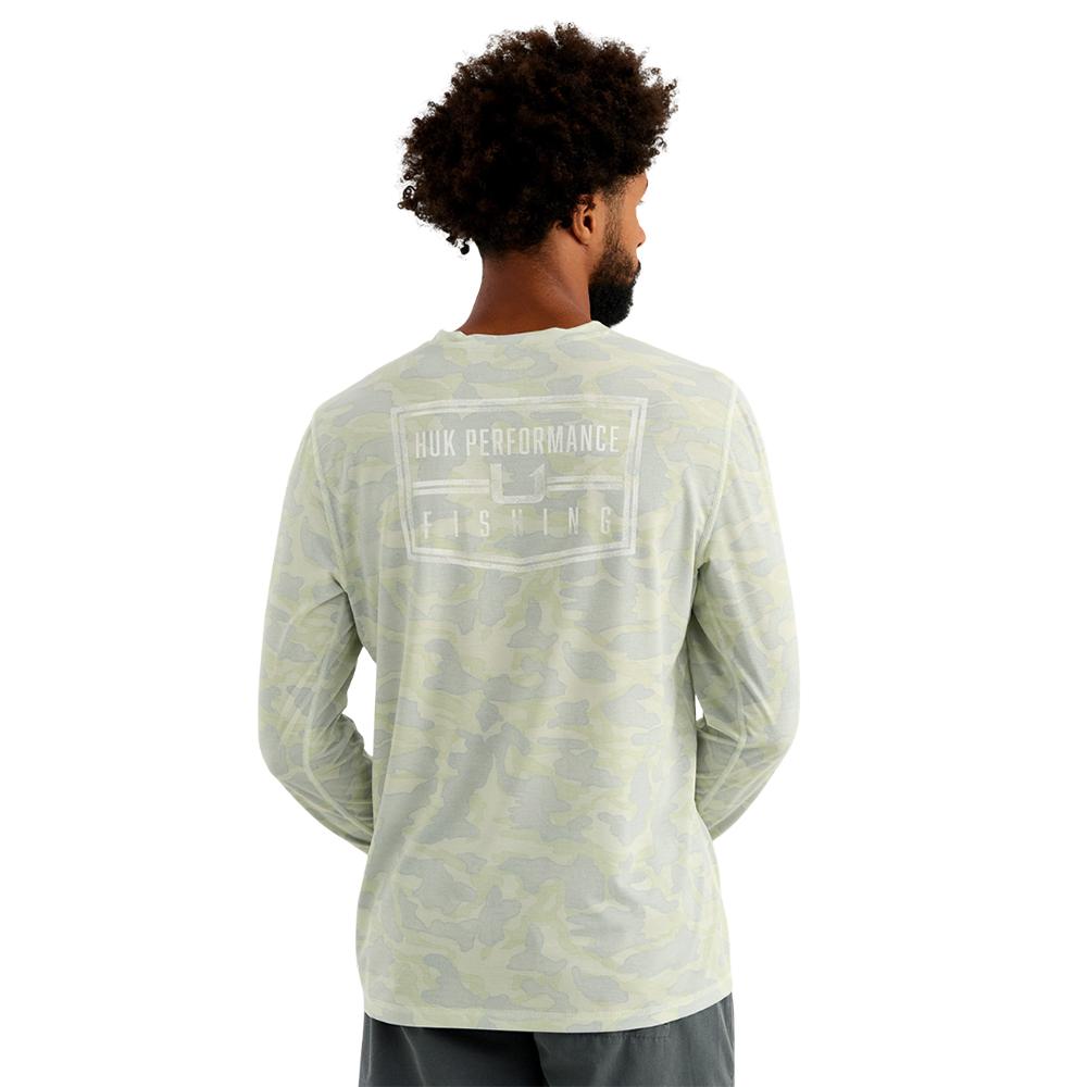 Man wearing camo Huk fishing shirt back view