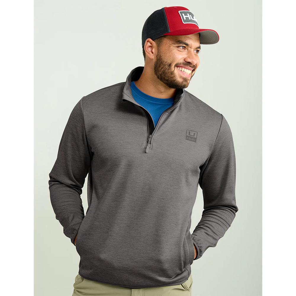 Smiling man in gray quarter-zip and cap
