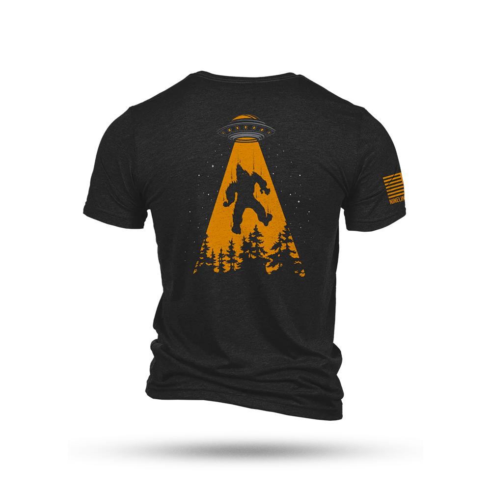 Black T-shirt with UFO abducting Bigfoot graphic