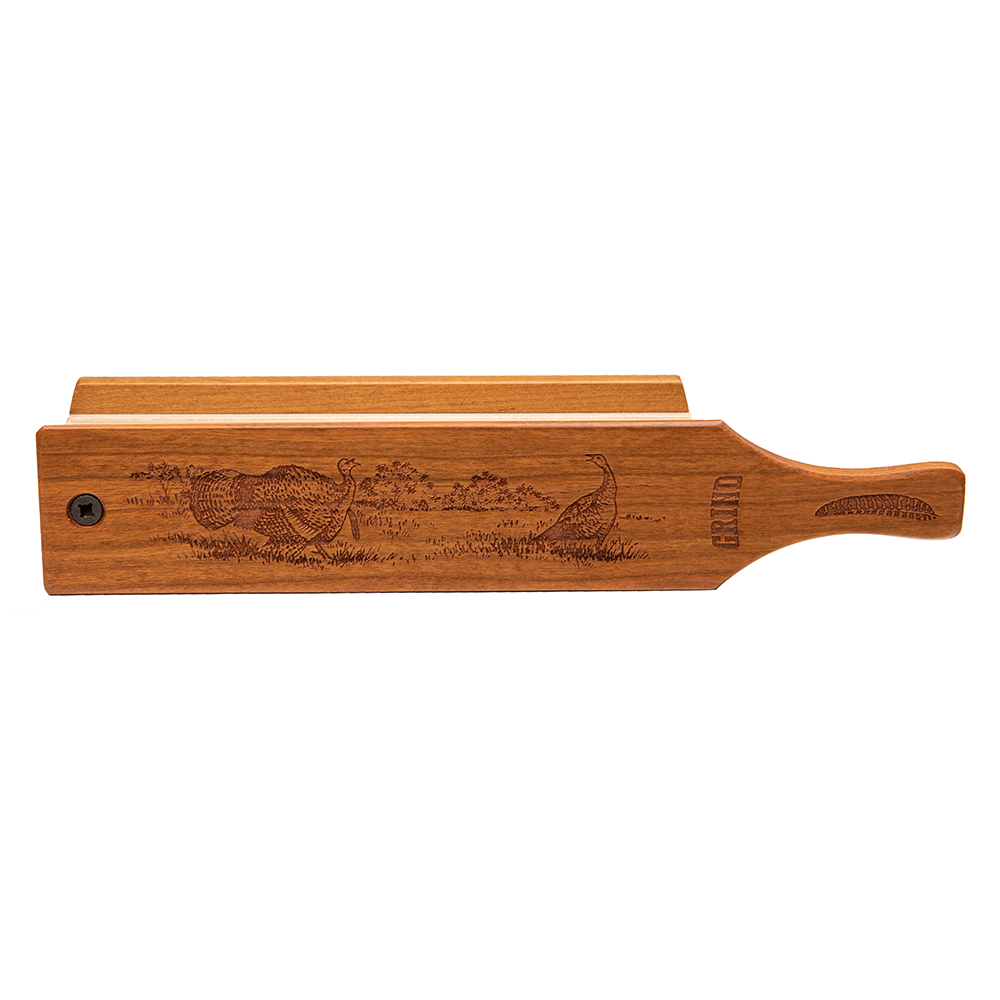 Wooden turkey call with engraved turkey scene