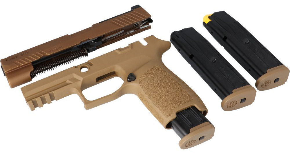 Disassembled semi-automatic handgun with magazines displayed