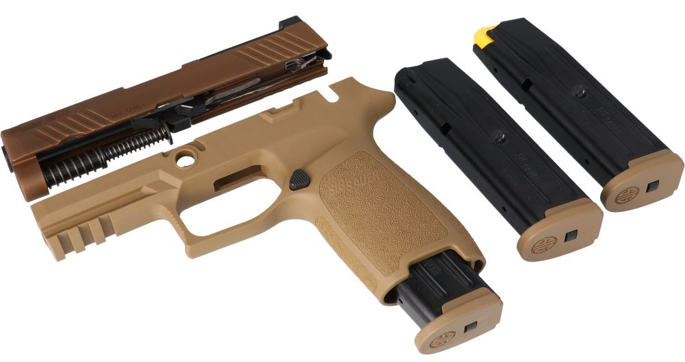 Disassembled semi-automatic pistol with three magazines