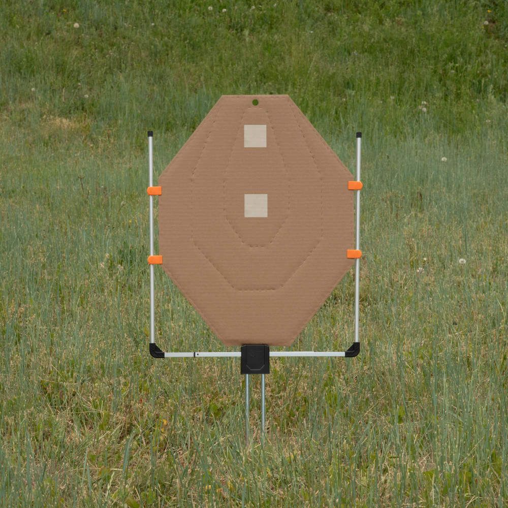 Cardboard silhouette target on stand in grassy field