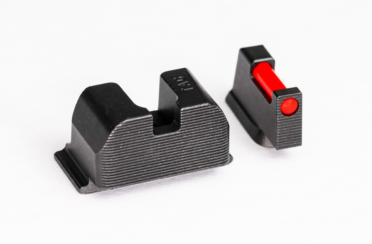 Black handgun iron sights with red fiber optic