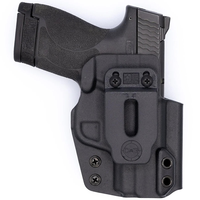 Compact handgun in black concealed carry holster
