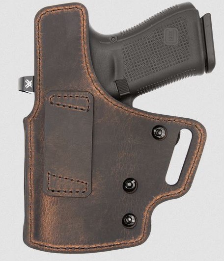 Handgun in brown leather holster