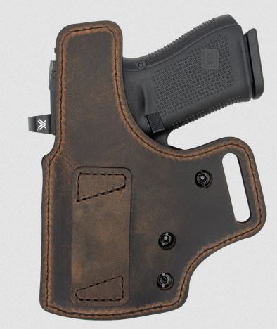 Handgun in brown leather holster