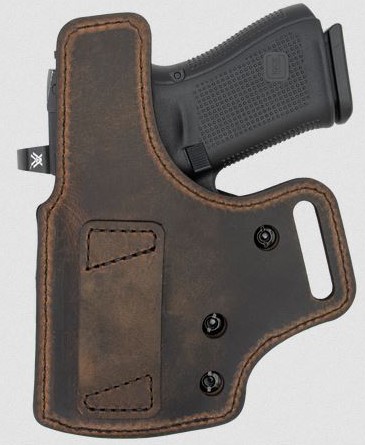Handgun in brown leather holster